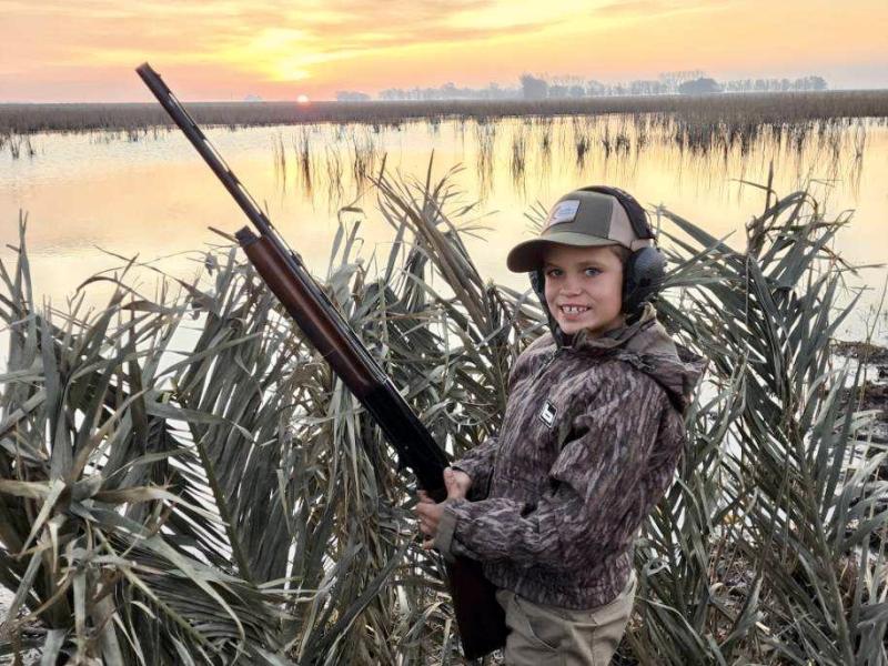 Seth Almond, 9 year old duck hunter, hiding in his blind in Argentina
