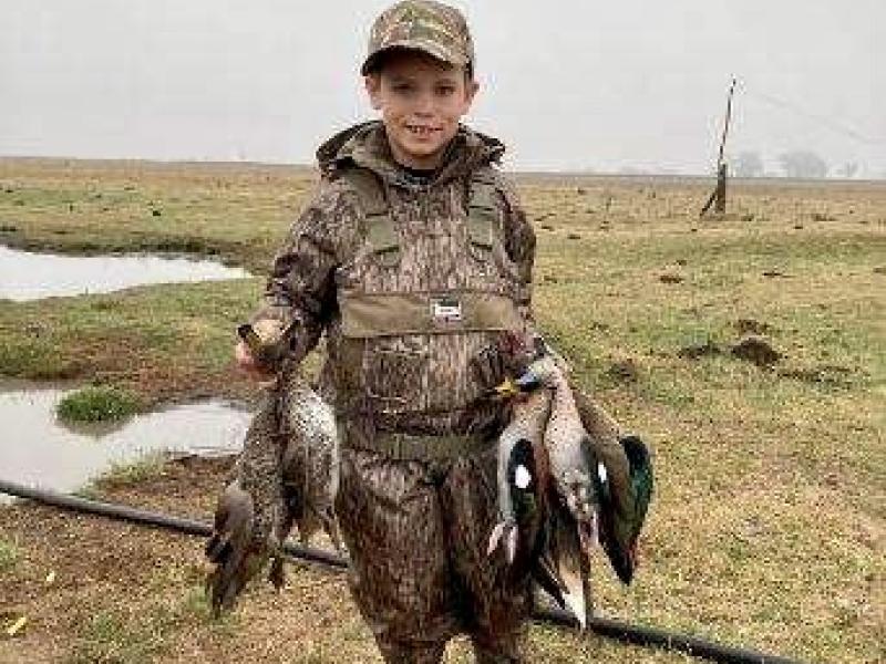 Seth Almond, 9 year old duck hunter, showing off some of his first Argentina ducks