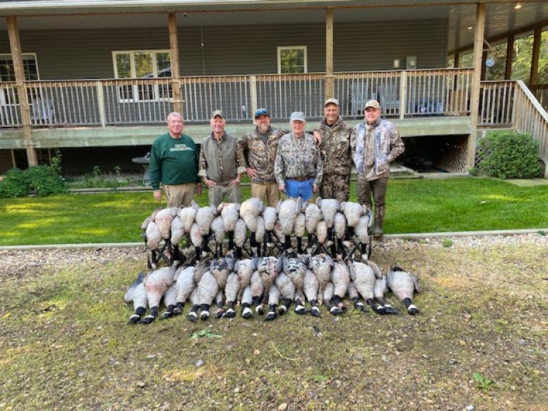 wings hunters with canada goose trophies