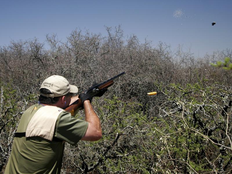 wings argentina hunter shooting rifle into air